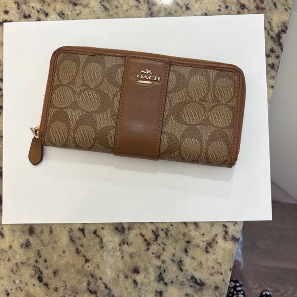 Coach Tan and Brown Signature Zip Wallet
PROJECT - Picture 2 of 9